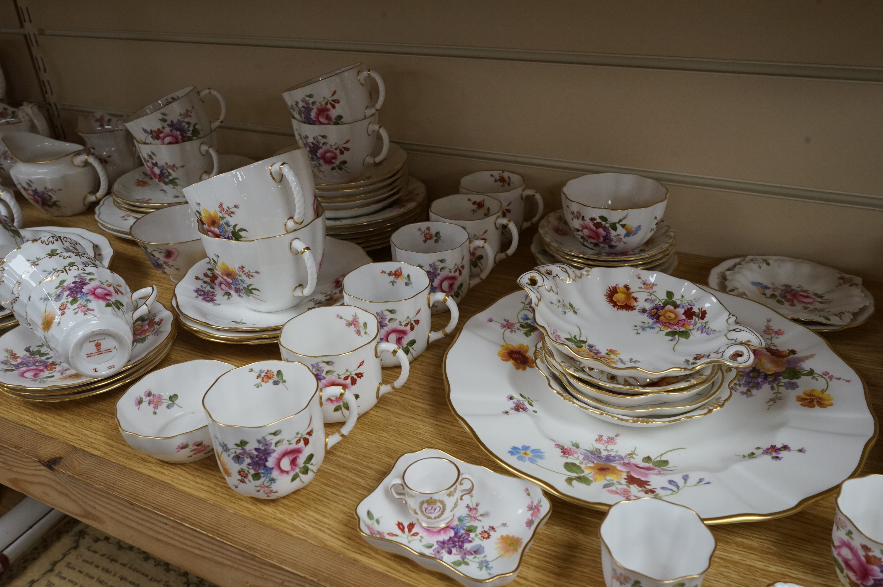 An extensive Crown Derby Posies pattern service to include trios, teapot, jugs and miniatures